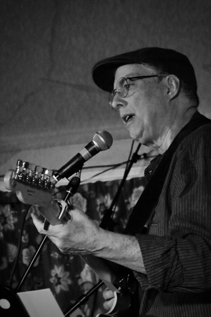 Micah Gilbert on guitar and vocals